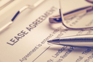 商业法律文件概念:笔和眼镜租赁协议表。租赁协议是出租人和承租人之间允许承租人有权使用出租人拥有的财产的合同
